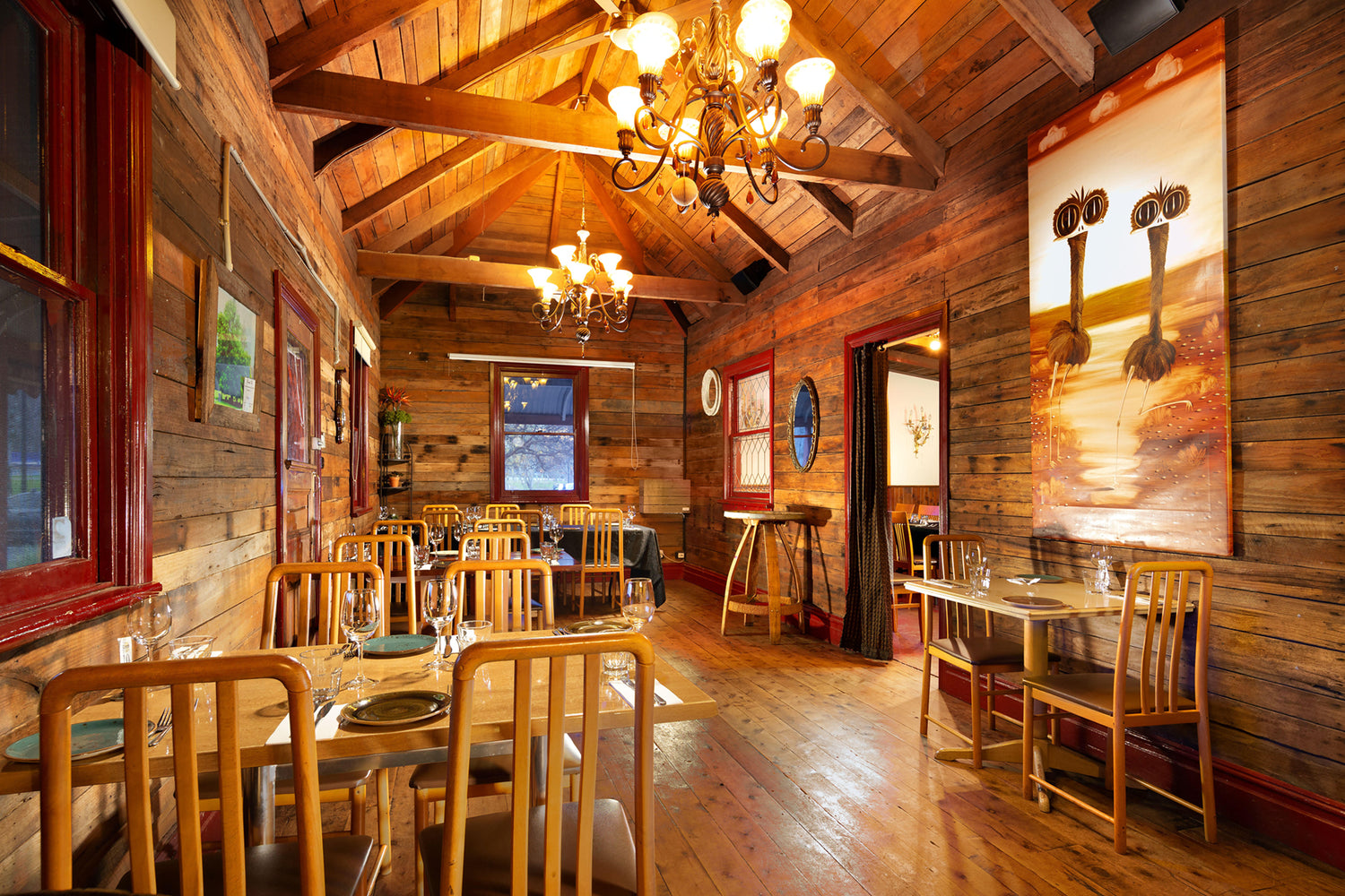 The Customs House with rustic decor, chandeliers and wooden tables.