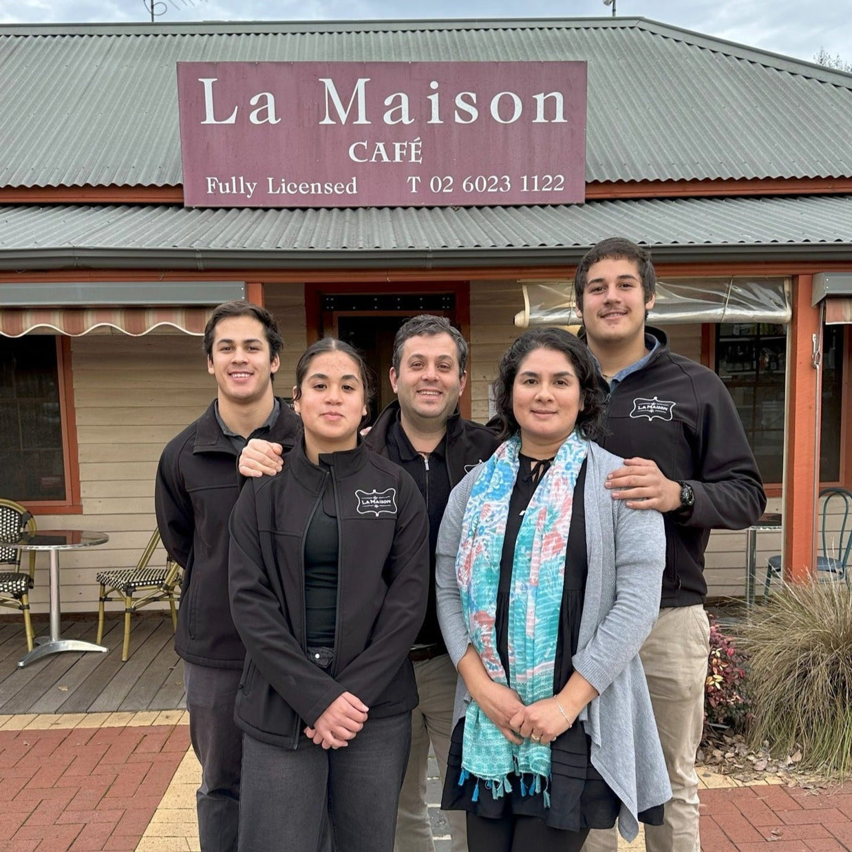 Saliba family pictured in front of La Maison sign.