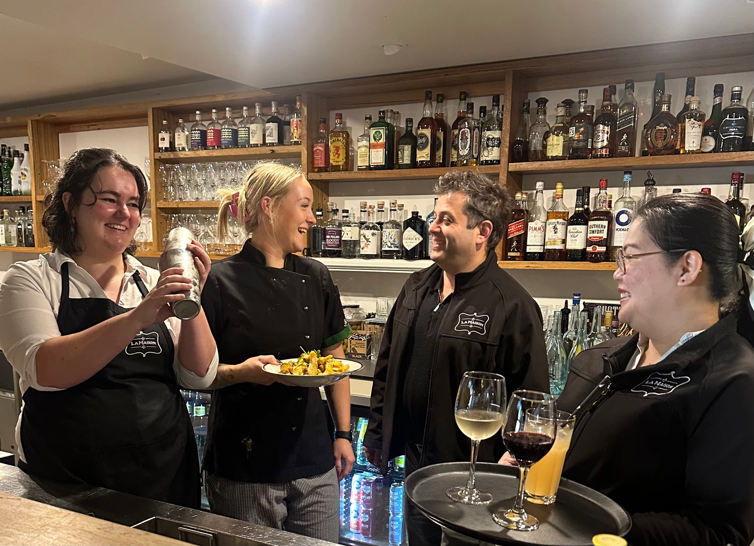 The staff of La Maison working behind the bar.